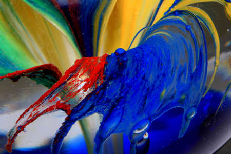 A Vibrant Abstract Glass Swirls and Bubbles from a Paperweight with Lines and Coloursの写真素材