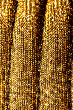 A Rippled Gold Sparkle Glitted Textured Background Close Upの写真素材