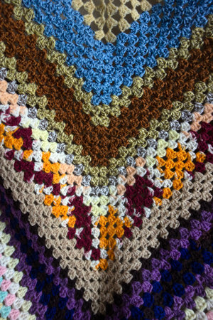 A Close Up of a Multicolour Crochet Knitted Blnket in Vintage Designの写真素材