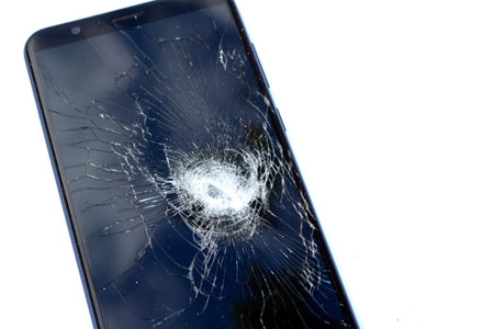 Smartphone Phone being Smashed By a Hammer the Glass is Shatteredの写真素材