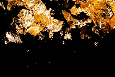 Vibrant Gold Leaf Pieces Close Up on A Background as Decorative Piecesの写真素材