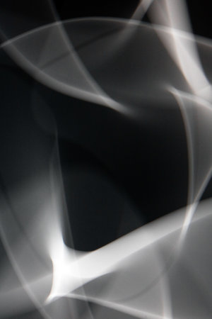 A Swirling White Smoke Light on a Black Backgroundの写真素材
