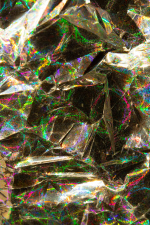 A Holographic Crumpled Gold Bronze Paper Material which is Shiny for Backgroundの写真素材