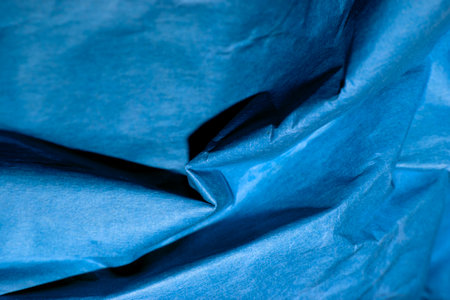 blue creased crumpled paper background grunge texture backdrop.の写真素材