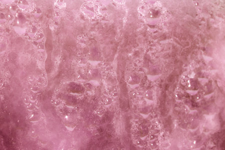 Deilcate Rain Drops of Water on Glass in a Red Pink Glow for Backgroundの写真素材