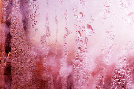 Delicate Rain Drops of Water on Glass in a Glow for Backgroundの写真素材