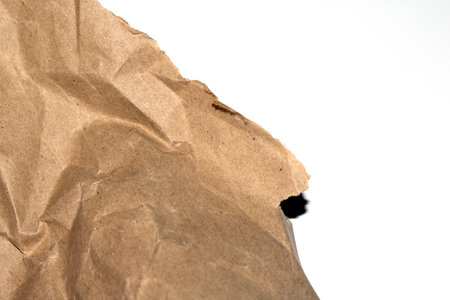 Ripped Up Torn Cardboard Box Packaging with Ridges on White Backgroundの写真素材