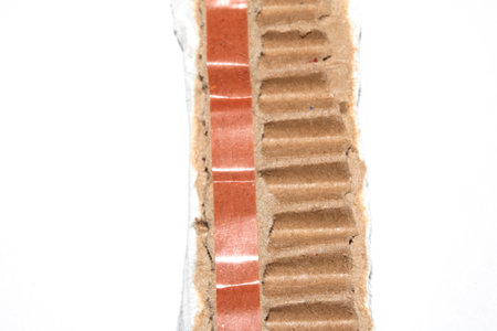 Ripped Up Torn Cardboard Box Packaging with Ridges on White Backgroundの写真素材