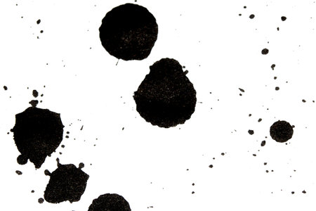 Black Messy Creative Ink Splatters Drips and Inkblot Close Up on White Backgroundの写真素材