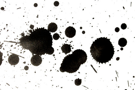 Black Messy Creative Ink Splatters Drips and Inkblot Close Up on White Backgroundの写真素材
