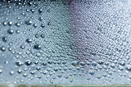 Rain Bubbles Drops Running down a Window on a Wet Day Abstract Background