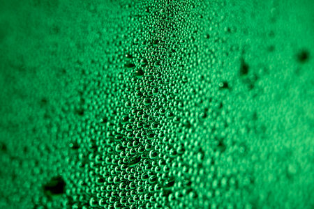 Close Up of Condensation Floating Liquid Water Bubbles and Drips on Glass from Rainの写真素材