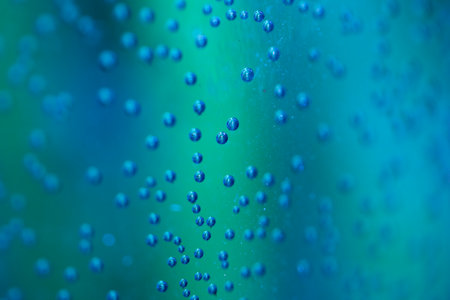 Close Up of Condensation Floating Liquid Water Bubbles and Drips on Glass from Rainの写真素材