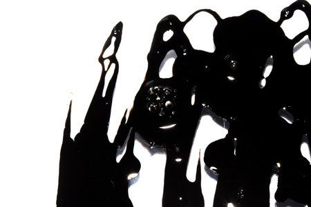 Black Messy Creative Ink Splatters Blots and Blobs  and Inkblot Close Up on White Backgroundの写真素材