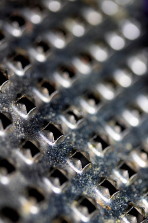 Close Up of a Steel Metal Perferated Hole Background Abstract Futeristic Circlesの写真素材