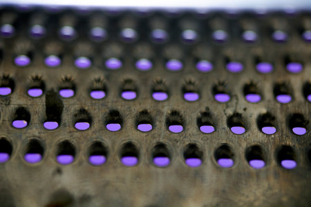 Close Up of a Steel Metal Perferated Hole Background Abstract Futeristic Circlesの写真素材