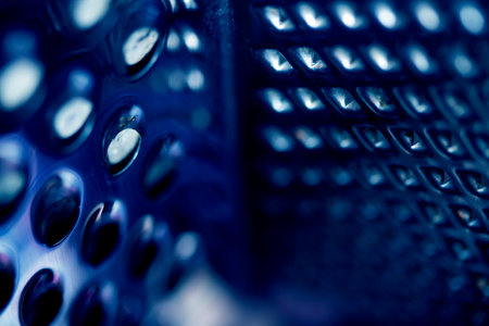 Close Up of a Steel Metal Perferated Hole Background Abstract Futeristic Circlesの写真素材