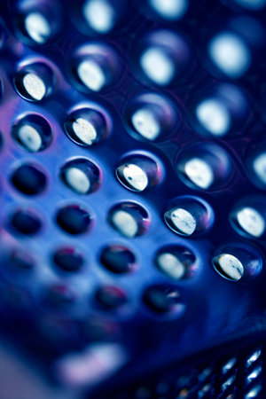Close Up of a Steel Metal Perferated Hole Background Abstract Futeristic Circlesの写真素材