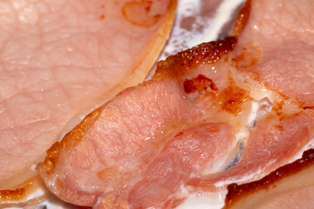 Close Up of Fried Grilled Bacon Slices On Tin Foilの写真素材