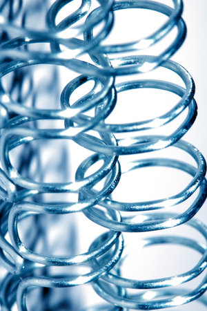 Abstract Close up of Metal Coil Spring Spiral Industrial Blue Backgroundの写真素材