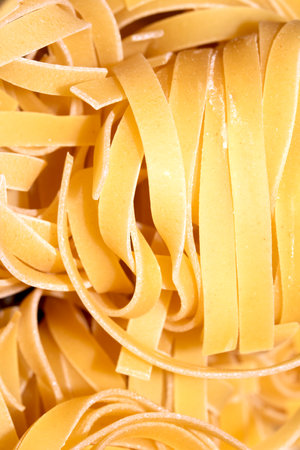 Close up of raw tagliatelle ribbon spaghetti pasta shapesの写真素材