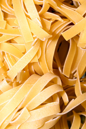 Close up of raw tagliatelle ribbon spaghetti pasta shapesの写真素材