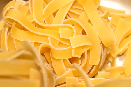 Close up of raw tagliatelle ribbon spaghetti pasta shapesの写真素材