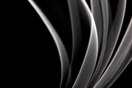 Black and White Light on Black Background Abstract Lines Swirls and Wavesの写真素材