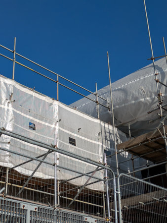 Large Industrial Building Covered and Surrounded with Scaffoldingの写真素材