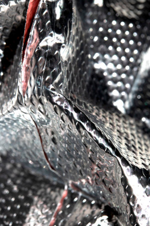 Industrial foil shiny background with rivets and crumpled linesの写真素材