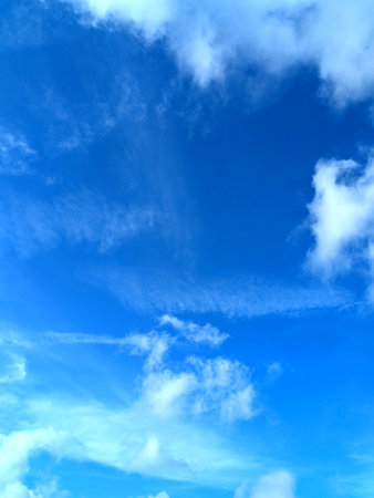 Bright Blue Sky and White Fluffy Clouds Whispy Skyline