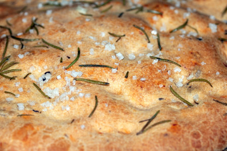 Close up of freshly baked focaccia bread  with salt and rosemary