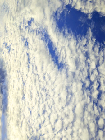 Abstract Thick White Fluffy Clouds on a Darker Blue Sky Background