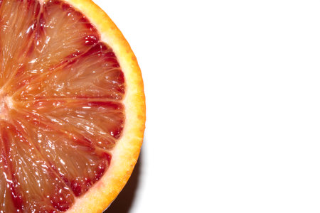 Blood Red Orange Slice Piece Fruit Cut Juicy Close up on White Backgroundの写真素材