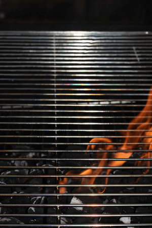 BBQ fire and grill with flames close up before cooking on charcoalの写真素材