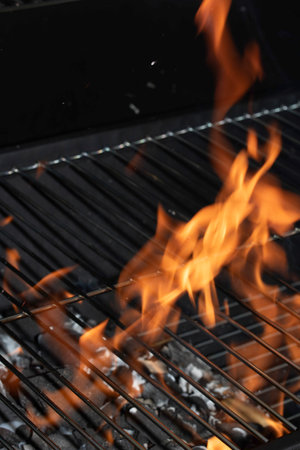 BBQ fire and grill with flames close up before cooking on charcoal
