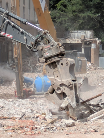 Demolition of Shopping centre Offices by an Industrial Grab Crusher Hydraulic Excavator