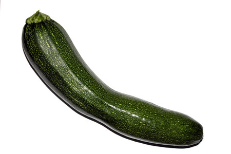 Close up of home grown courgette zucchini baby marrow vegetable skin  green on white backgroundの写真素材