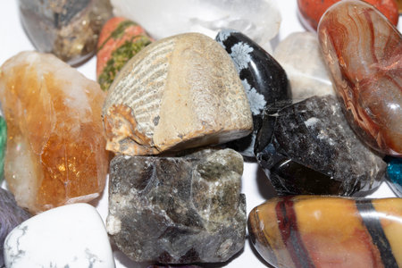 Collection of holistic healing crystal pieces and rocks spiritual on a white background tigers eye...