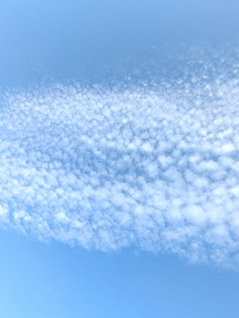 Pretty blue sky with bubble style white clouds floating atmosphere gentle skyscape