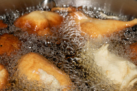 Close up of frying batter in oil chicken balls home made