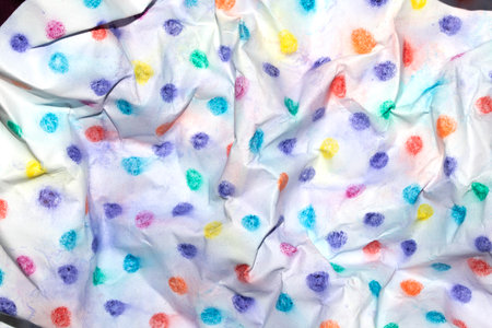 Crumpled paper with children's pencil crayon spotty polka dots backgroundの写真素材
