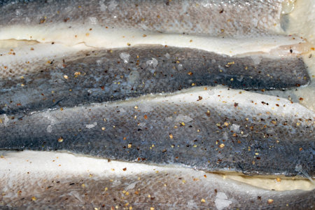 Macro close up of raw basa fish skin with scale detail ready for cooking