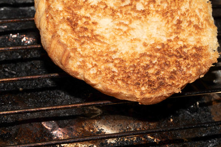 Close up of toasted burger bun being grilledの写真素材