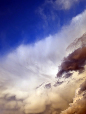 Thick stormy thunderstorm clouds in a blue skyの写真素材
