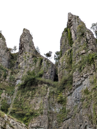 Tall cliff face jagged rocks and stone gorge mountains with clear sky in the UK landscapeの写真素材
