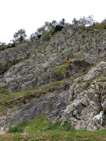 Tall cliff face jagged rocks and stone gorge mountins with clear sky in the UK landscapeの写真素材