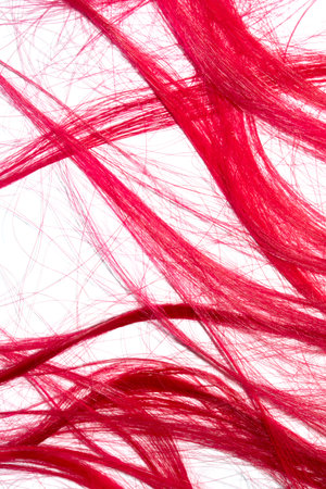 Bright red hair strands swirls on white backgroundの写真素材