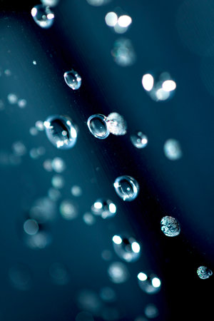 Close up of abstract floating bubbles water droplets condensation rain on a glass transparent bokeh...