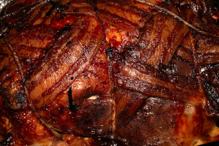 Close up of bacon covered roast chicken cooked in the oven and meat ready to be eaten